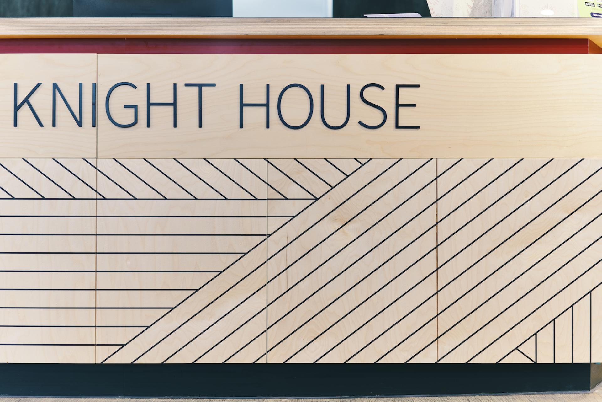 Stylish reception desk at Knight House, featuring modern design and wood finish for student accommodation at University of Sheffield.