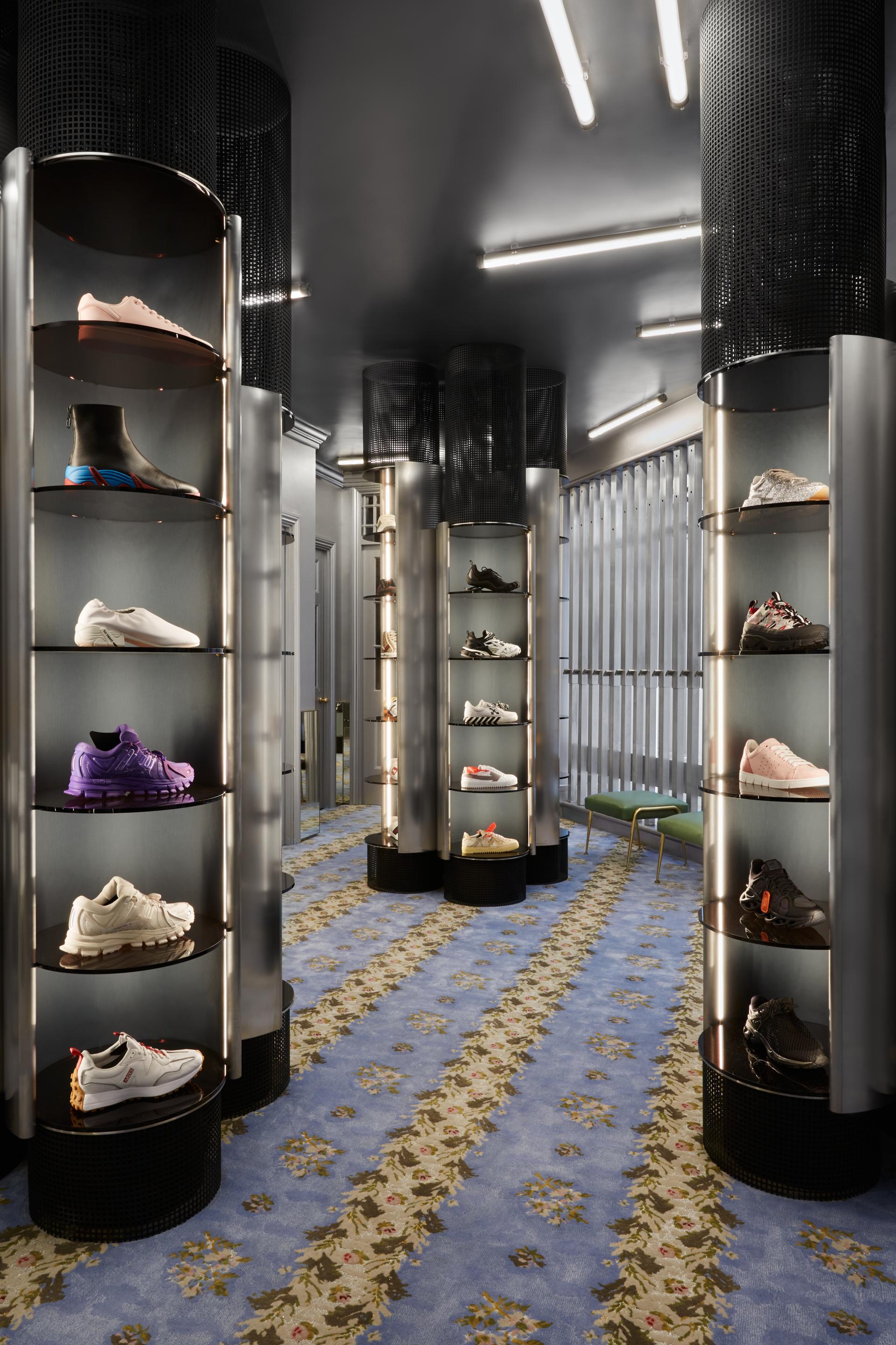 Contemporary retail lighting design showcasing stylish shoe displays in a luxury London boutique, enhancing the shopping experience.