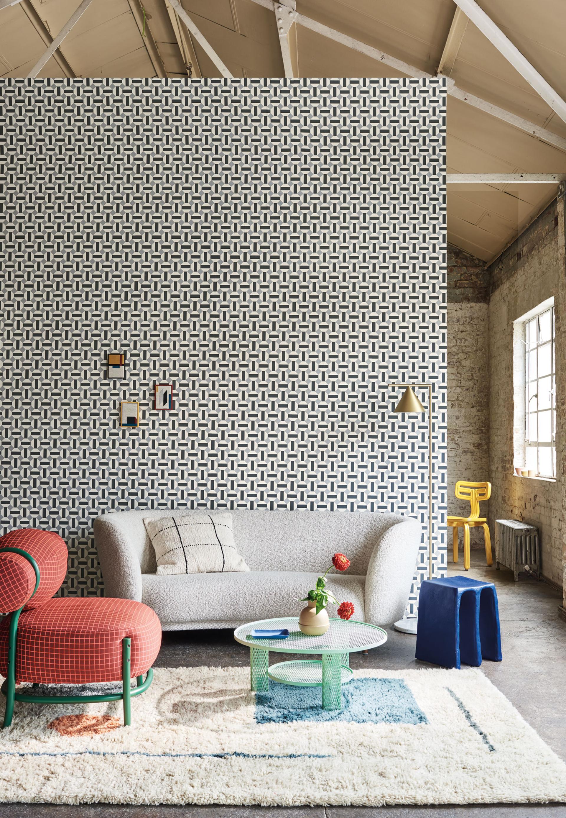 Stylish interior featuring Cole & Son's Seville wallpaper, contemporary furniture, and colorful decor accents in a chic setting.