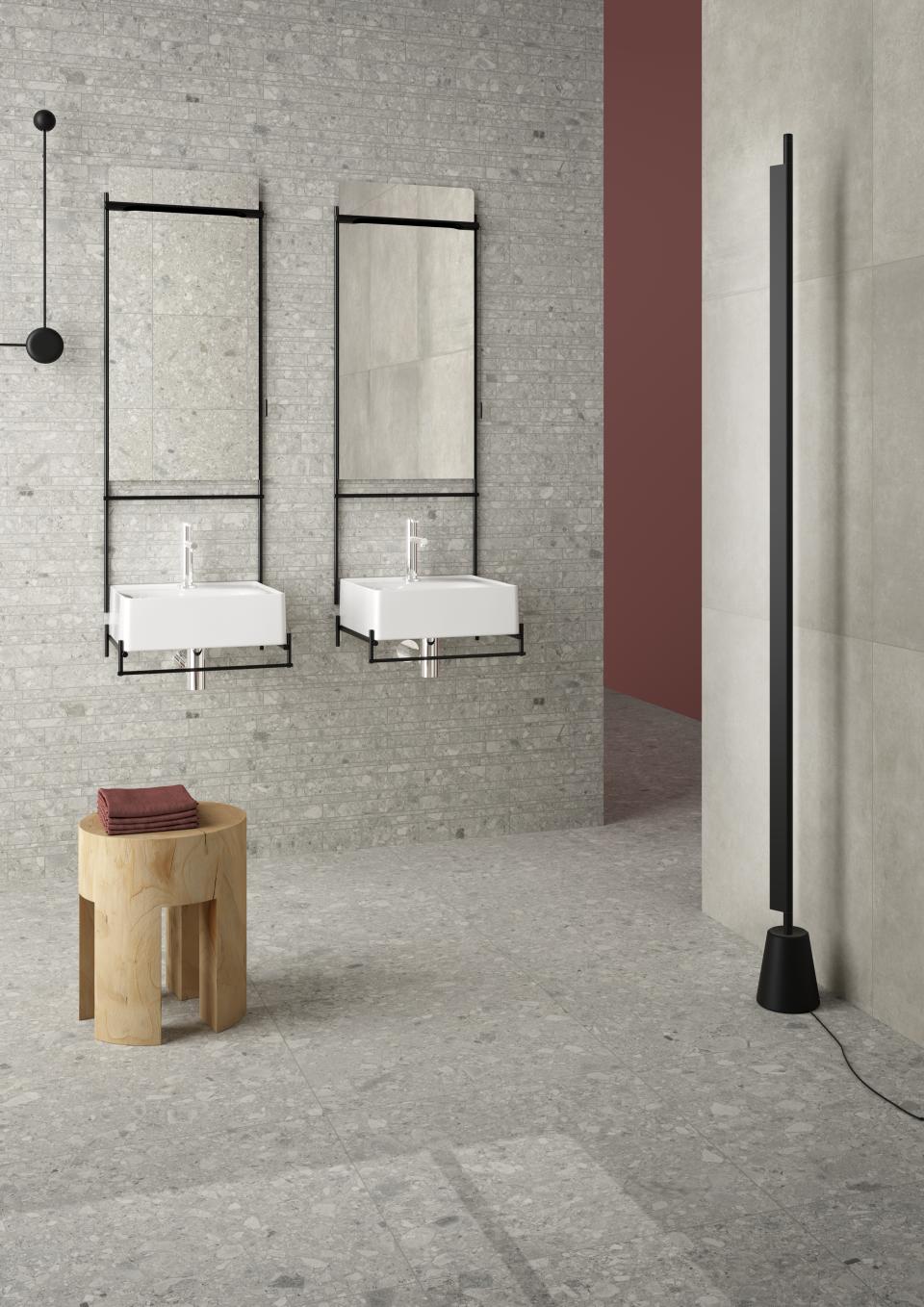 Sleek bathroom design featuring VitrA's textured tiles, wall-mounted sinks, and modern decor elements showcased at Cersaie 2018.