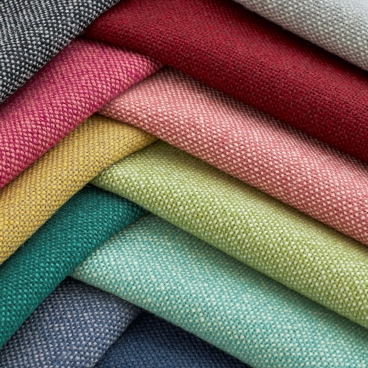 Textiles in various colors from Woven Image's new Airport wool-rich upholstery fabric collection, showcasing rich textures and hues.
