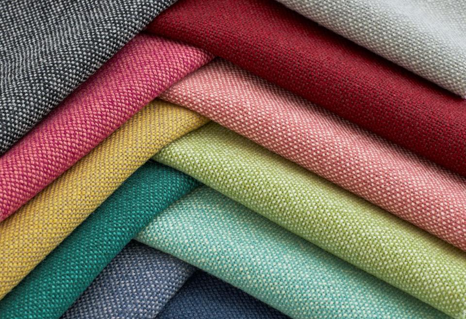 Textiles in various colors from Woven Image's new Airport wool-rich upholstery fabric collection, showcasing rich textures and hues.