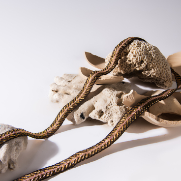 Artistic display of sculptural design elements, including textured coral pieces and braided textile, reflecting contemporary craftsmanship.