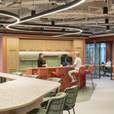 Modern office interior of Virgin Media O2 headquarters featuring collaborative spaces, stylish seating, and vibrant design elements.