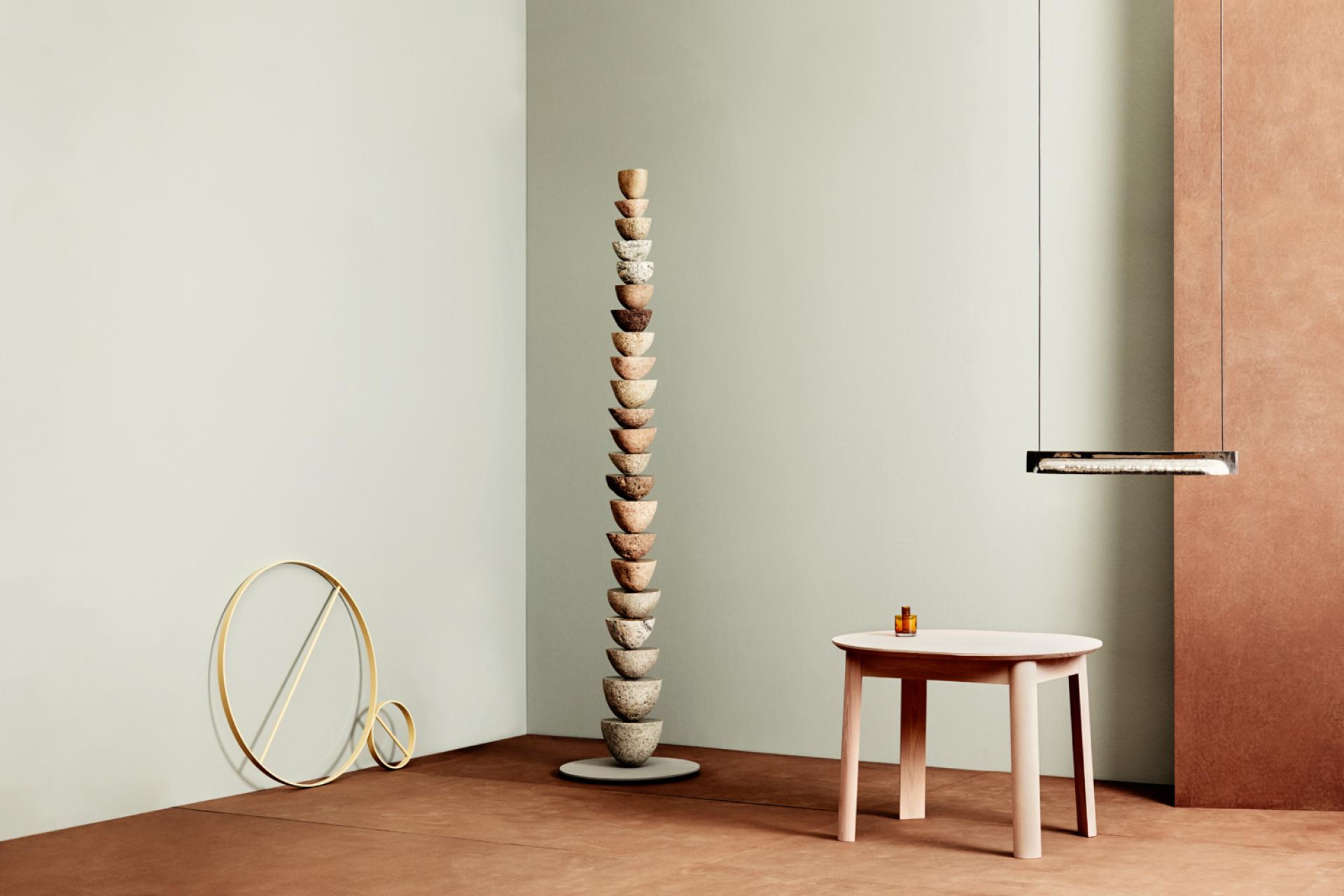 Sculptural stacking bowls and a minimalist wooden table showcase contemporary Norwegian design at the Salone exhibition.