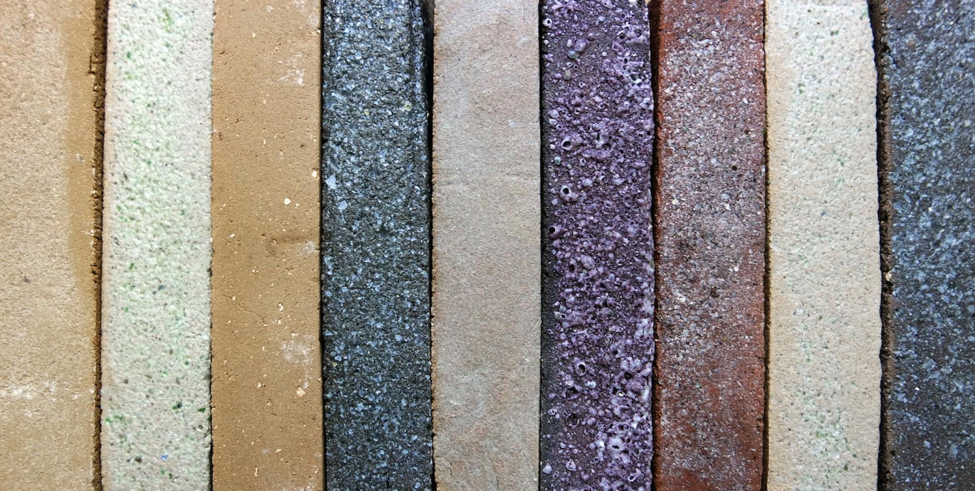 Colorful, eco-friendly bricks made from recycled materials, showcasing StoneCycling's innovative sustainable building solutions.