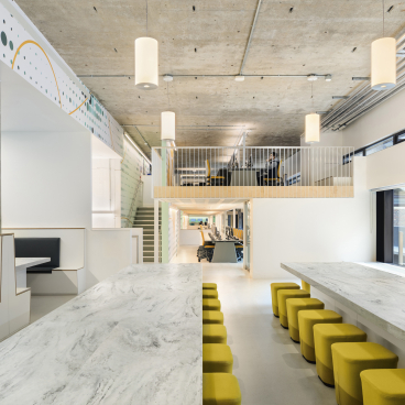 Modern workspace featuring Corian surfaces, colorful seating, and an open layout, showcasing the new 2021 colour range by CDUK.