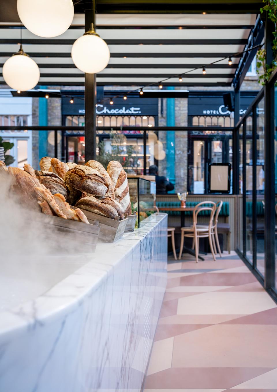 Vibrant bakery display showcasing artisanal bread at the newly designed Buns & Buns restaurant in Covent Garden.