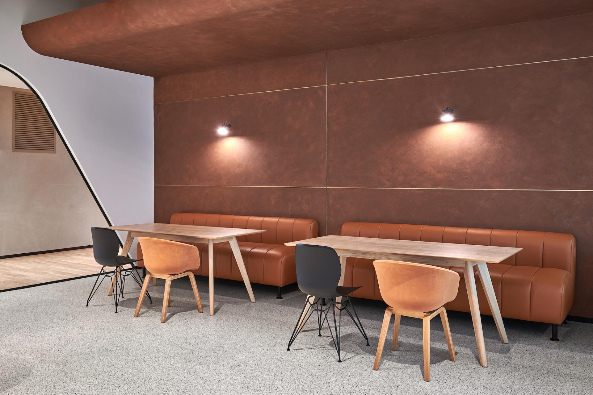 Cozy workspace in Sharjah Entrepreneurship Center featuring modern wooden tables and comfortable seating for collaborative meetings.