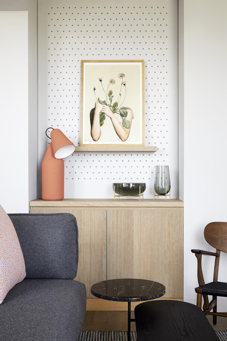 Warm, contemporary interior of PURO Kraków Kazimierz showcasing a stylish lamp, artwork, and elegant furnishings.