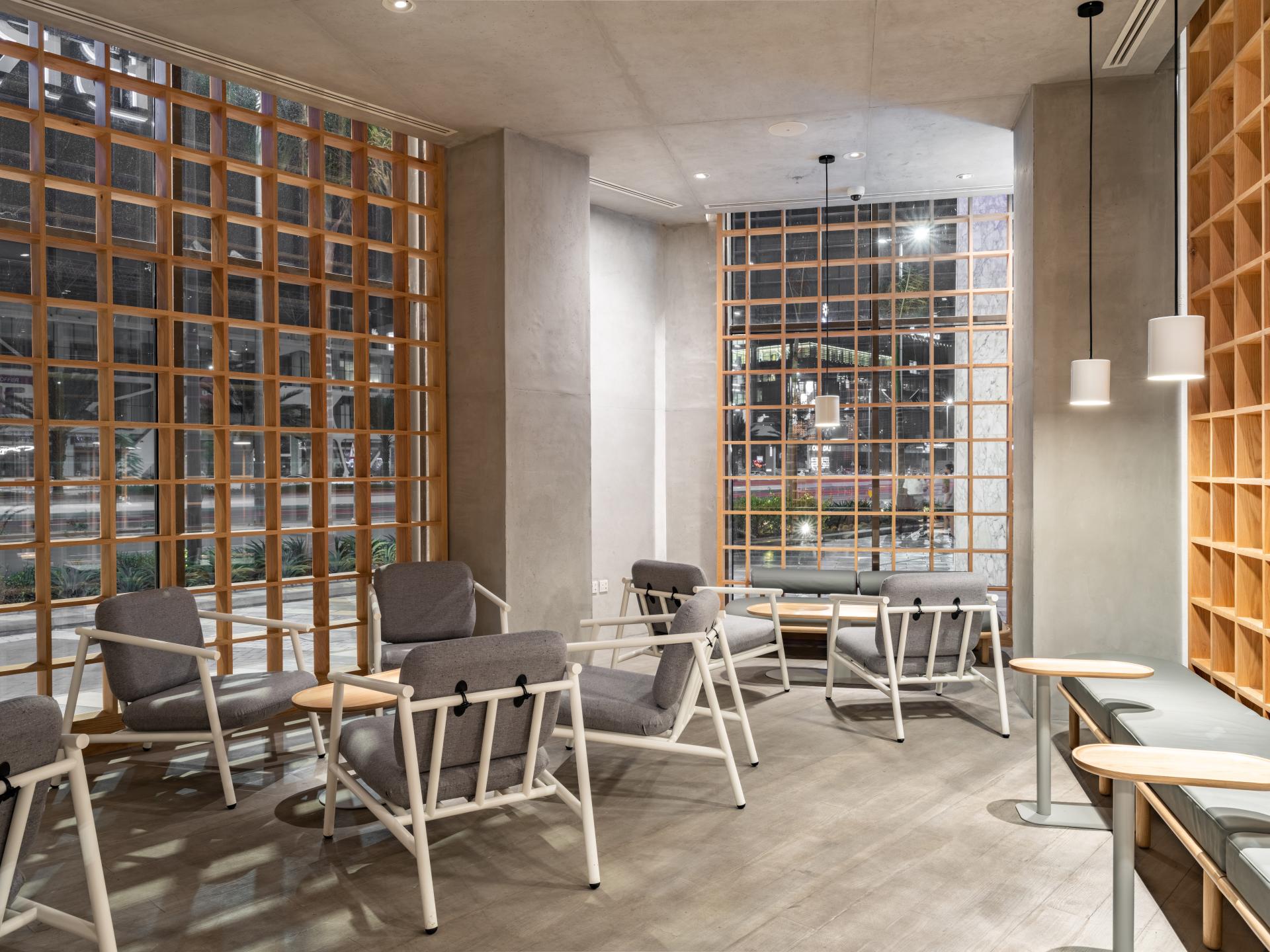 Stylish Japandi-inspired interior of Brew92's coffee shop showcasing modern seating and wooden accents.