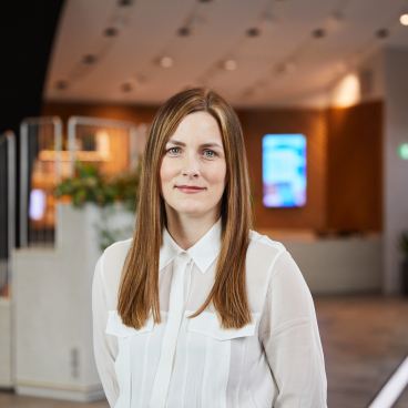 Aimee Holloran from Samsung Climate Solutions, highlighting women's representation in plumbing within a modern office environment.