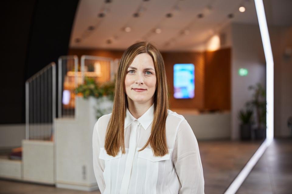 Aimee Holloran from Samsung Climate Solutions, highlighting women's representation in plumbing within a modern office environment.