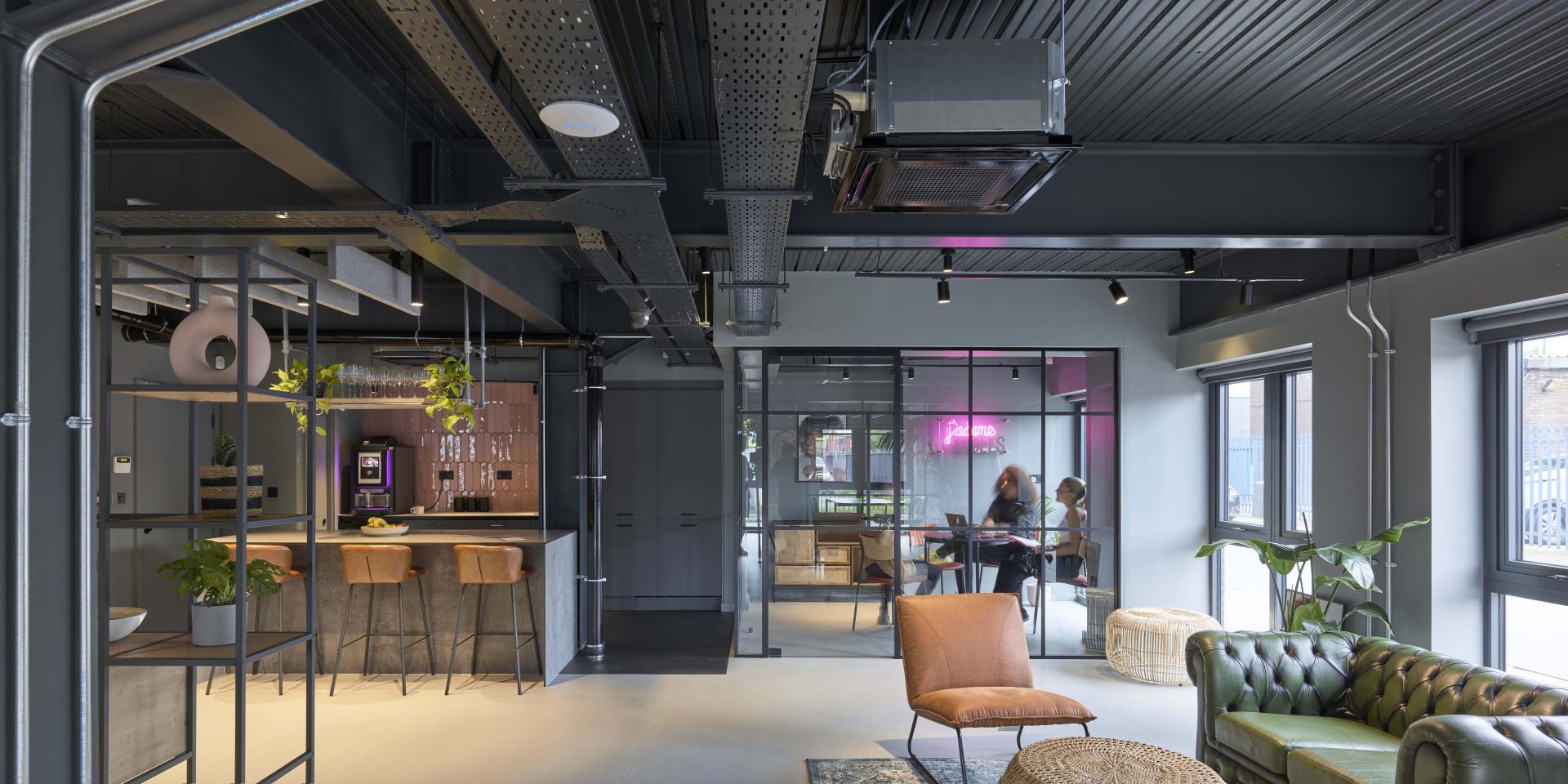 Modern office interior of J’adore Models HQ featuring a stylish bar, cozy seating, and collaborative spaces.