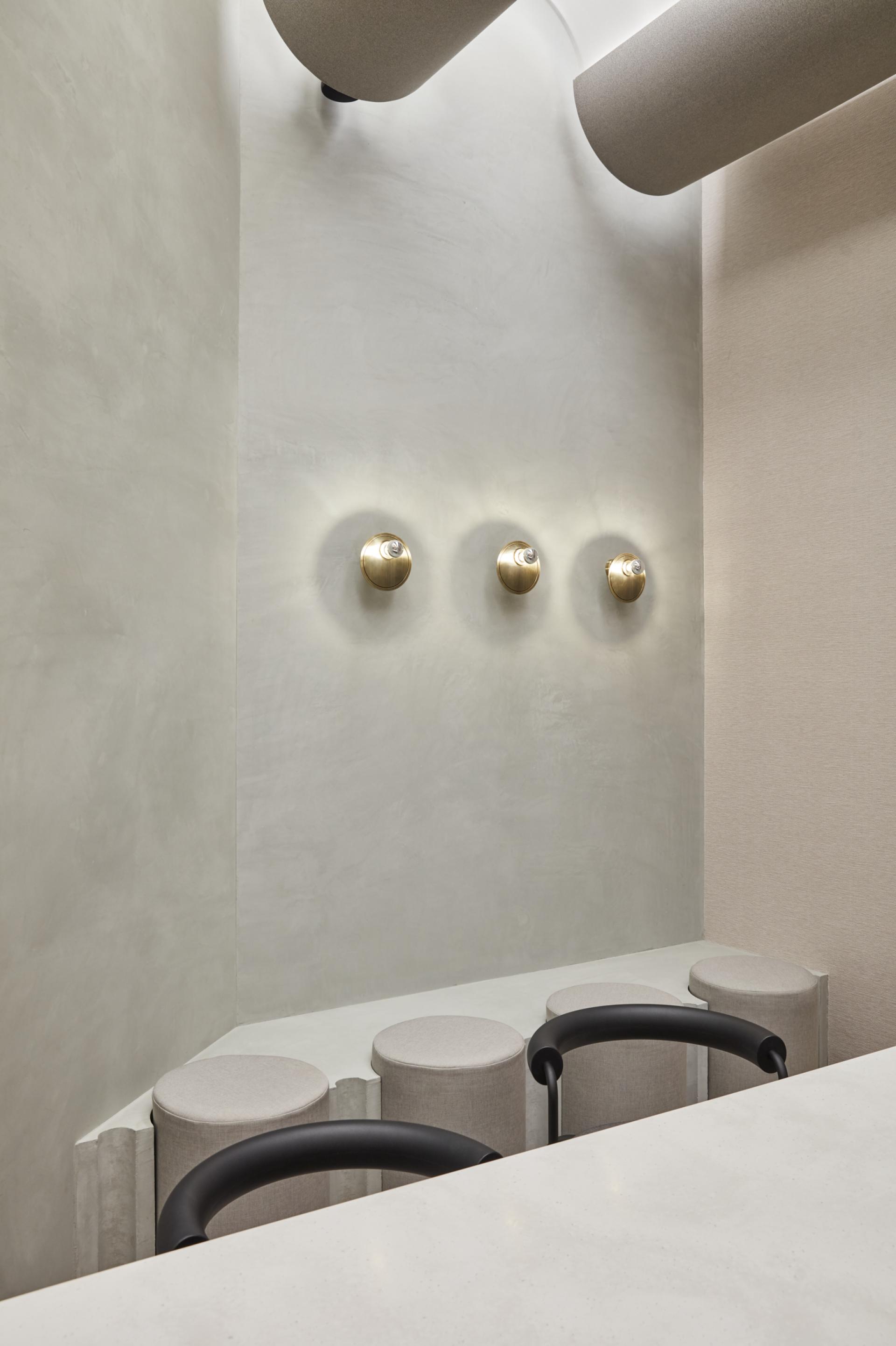 Sleek interior design of Niche cultural hub in Dubai, featuring modern lighting and minimalist seating arrangements.