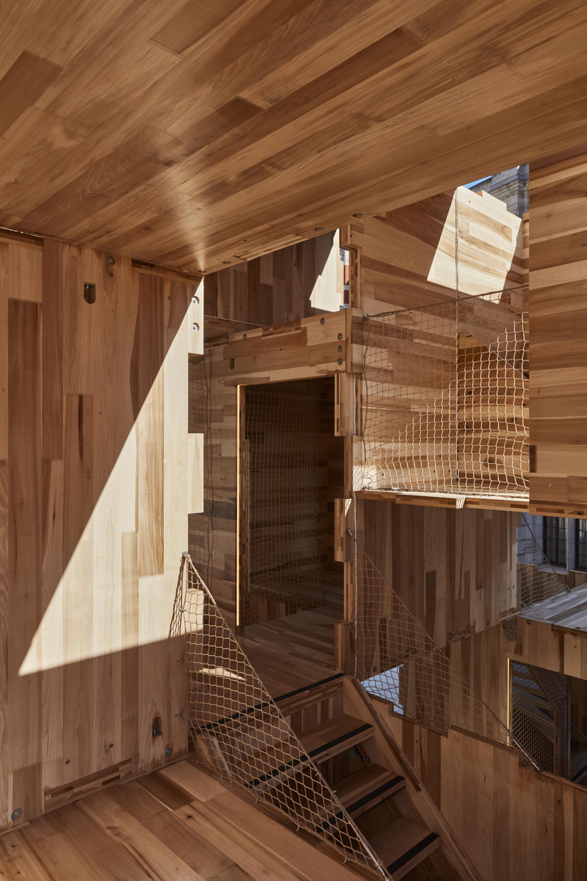 Interior view of the carbon-neutral MultiPly wooden pavilion showcasing American tulipwood features and open space design.