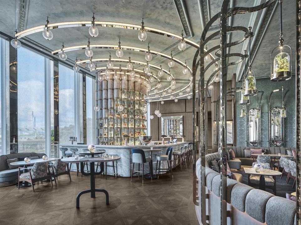 Stylish interior of Argo cocktail bar at Four Seasons Hong Kong, featuring elegant furnishings and a distinctive mirrored bar.