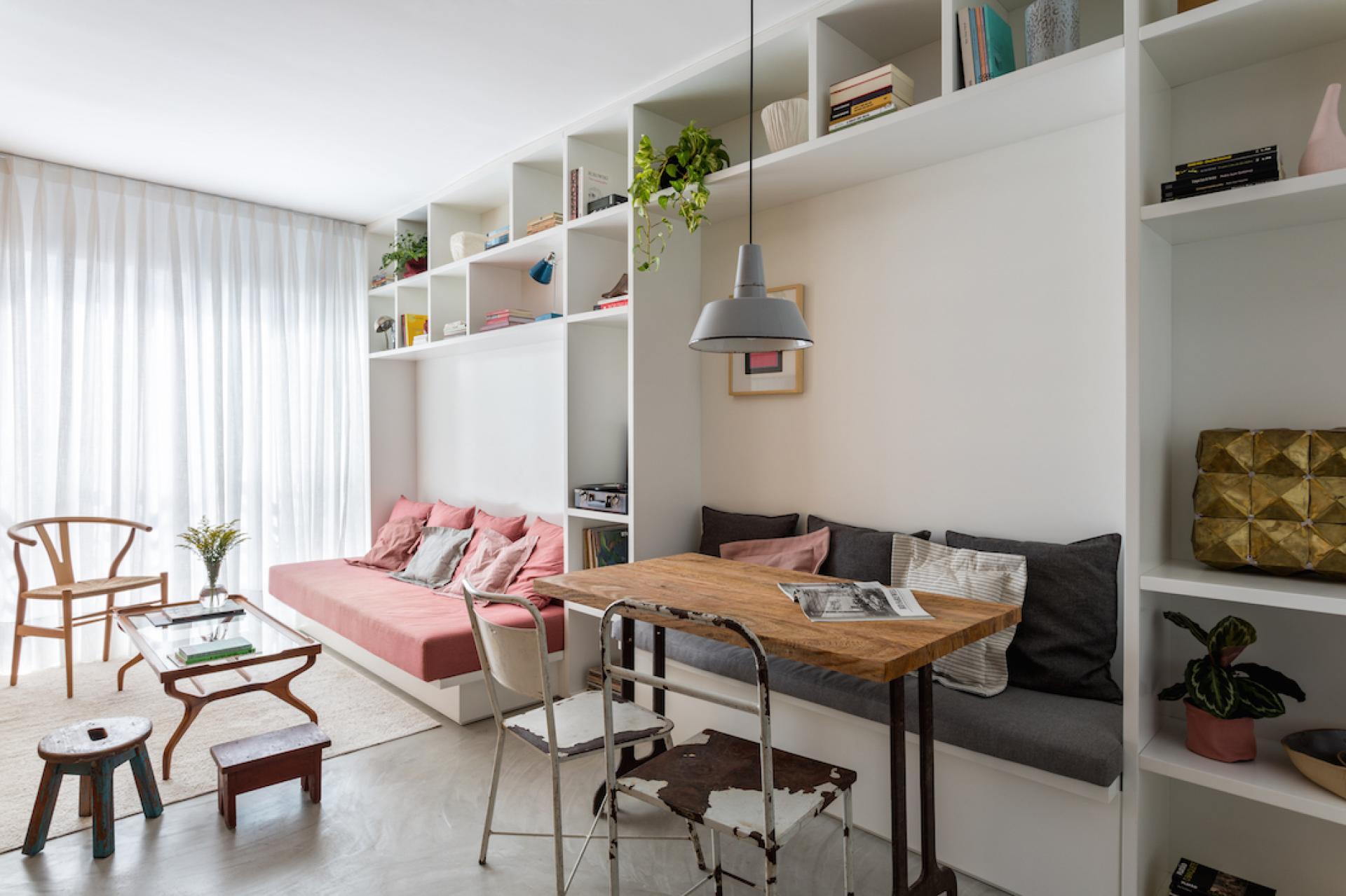 Modern compact apartment interior by Leandro Garcia featuring stylish seating, ample storage, and a cozy dining area.