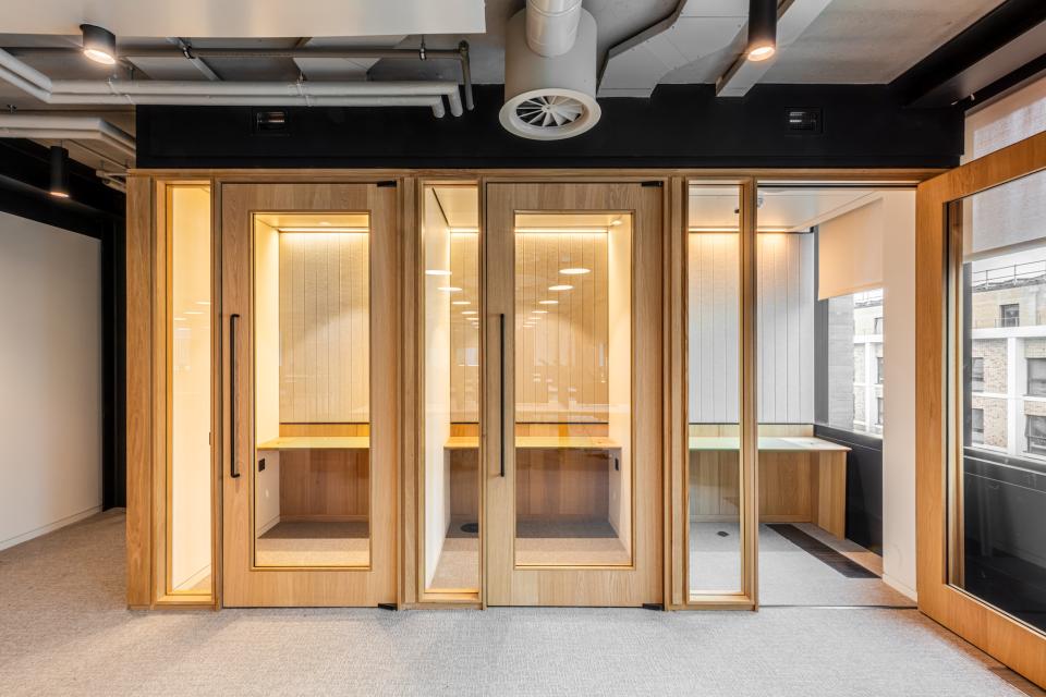 Bespoke timber-framed glazed partitioning creating private workspaces in Boston Consulting Group's new London office.