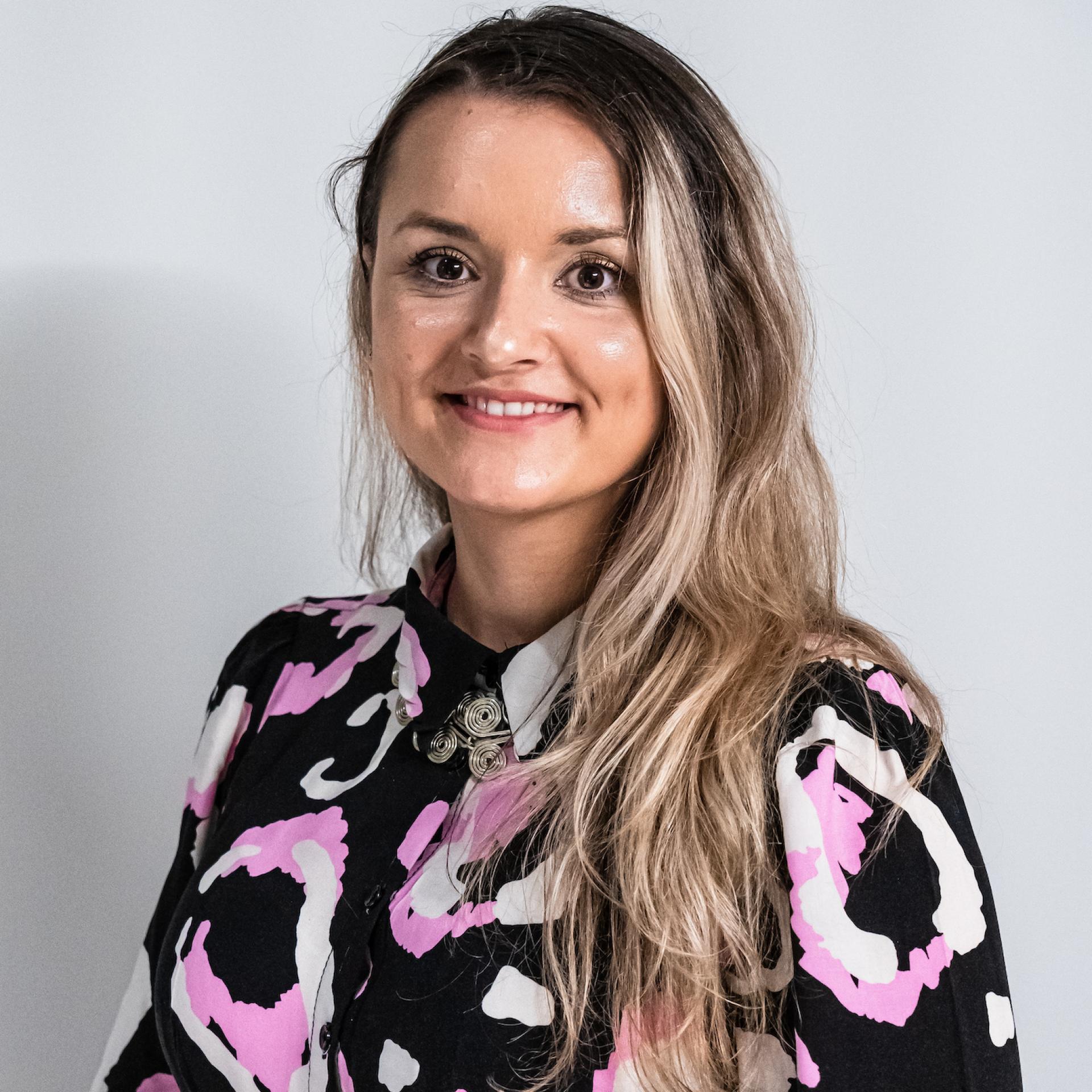 Manchester property expert smiling, wearing a vibrant patterned shirt, discussing BTR and co-living trends in the sector.