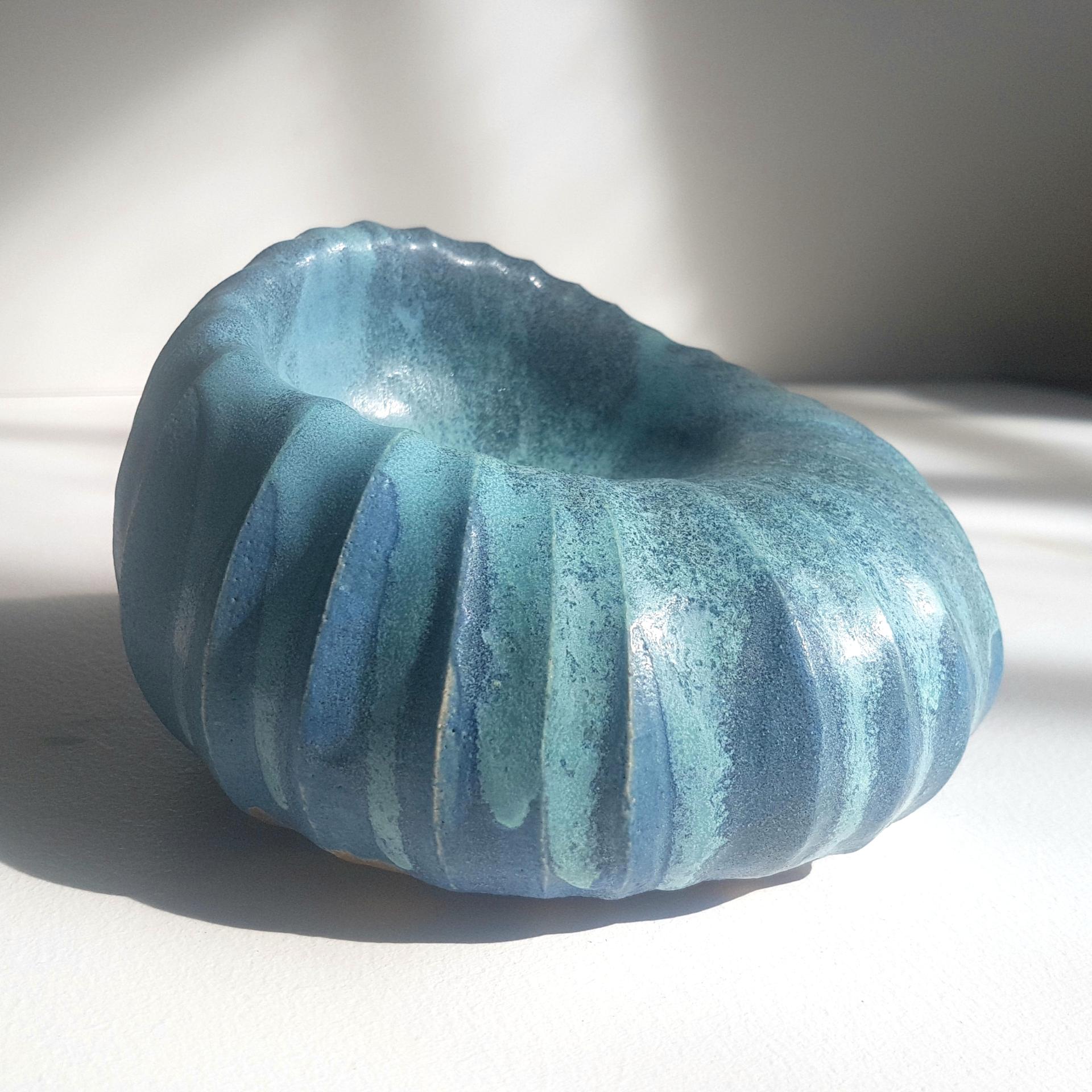 Unique blue ceramic bowl with textured ridges, reflecting Michele Bianco's passion for natural materials in her Highland studio.