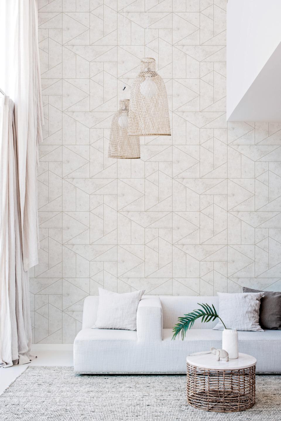 Stylish living room featuring Tektura Wallcoverings' geometric wallpaper, modern sofa, and decorative lighting.