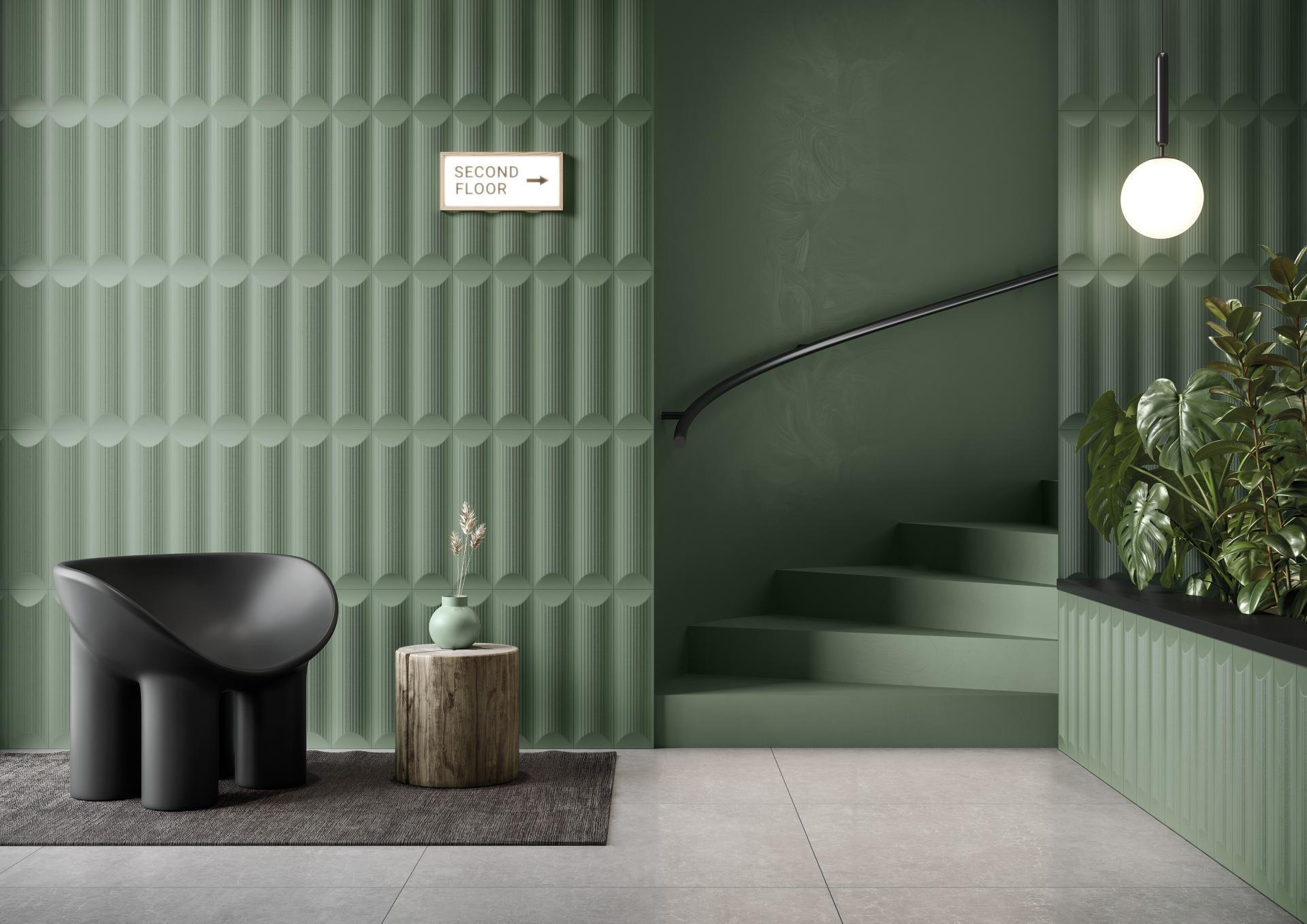 Modern interior featuring green textured walls, a black armchair, decorative plants, and contemporary lighting design.