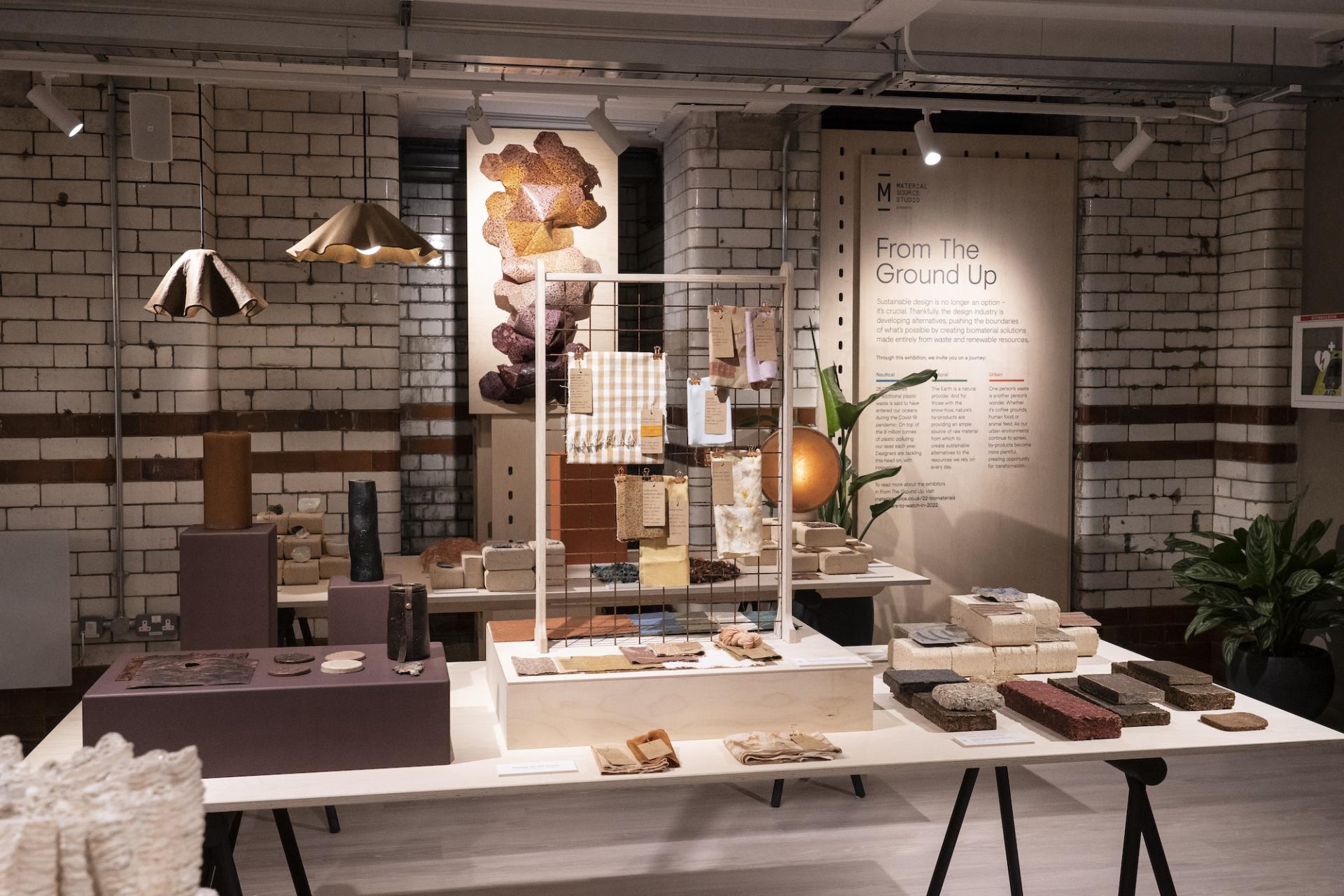 Exhibition display featuring sustainable materials and biomimetic design, highlighting From The Ground Up themes and innovations.