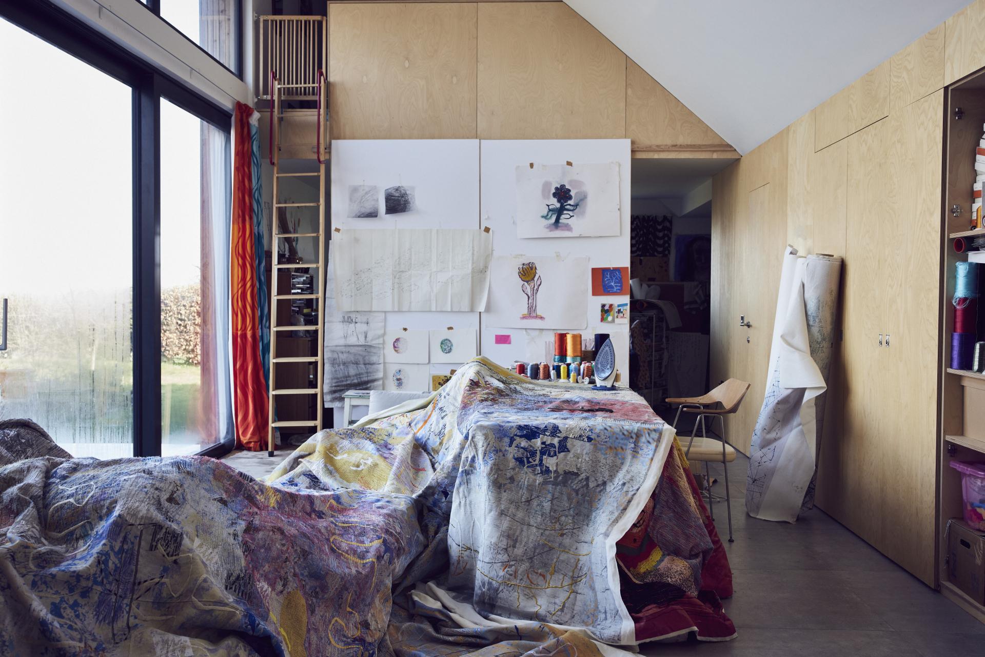 Textiles studio of Manchester artist Alice Kettle, featuring vibrant fabrics, artistic sketches, and a creative workspace environment.