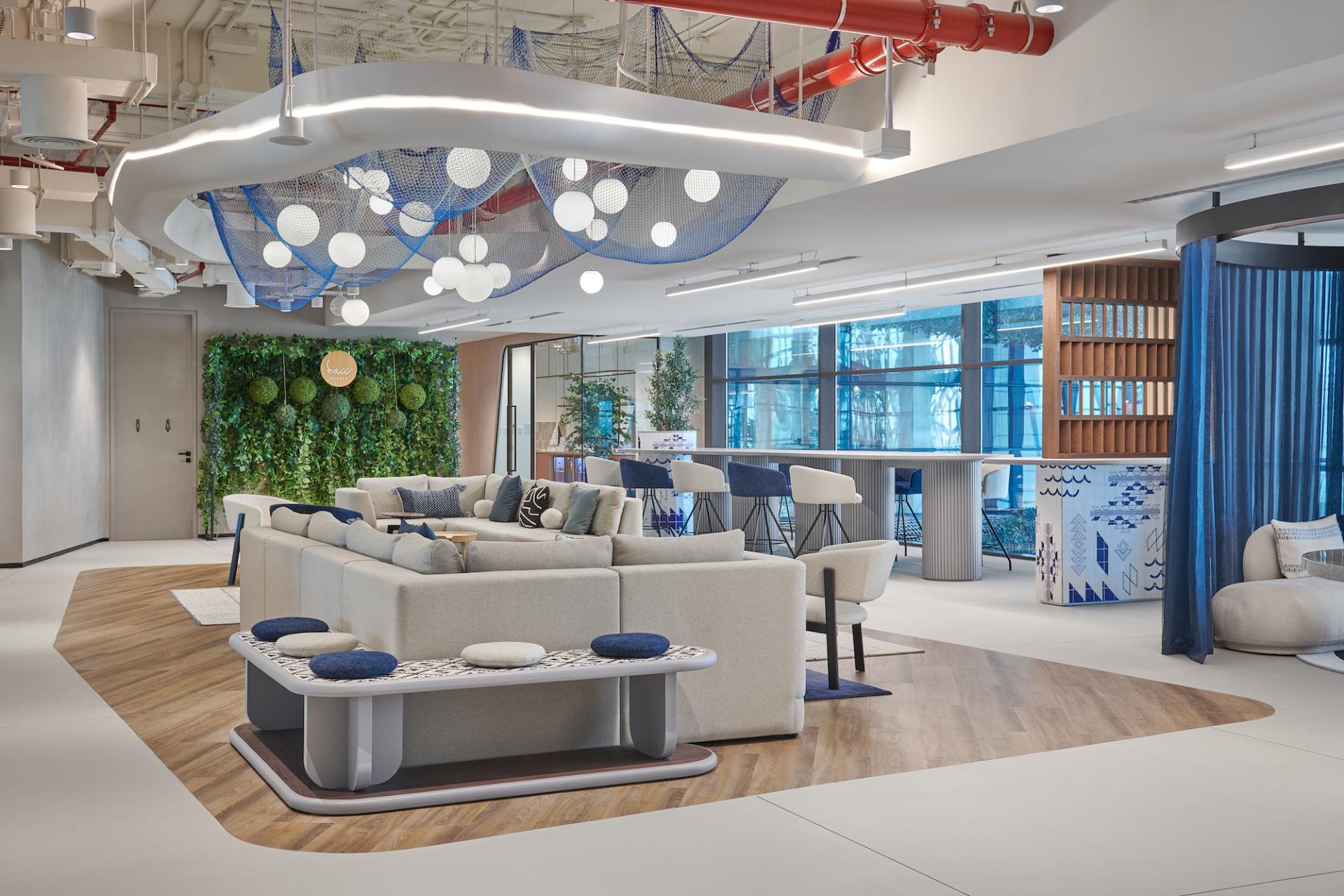 Vibrant co-working space at Sharjah Entrepreneurship Center featuring modern furnishings, greenery, and collaborative areas for entrepreneurs.