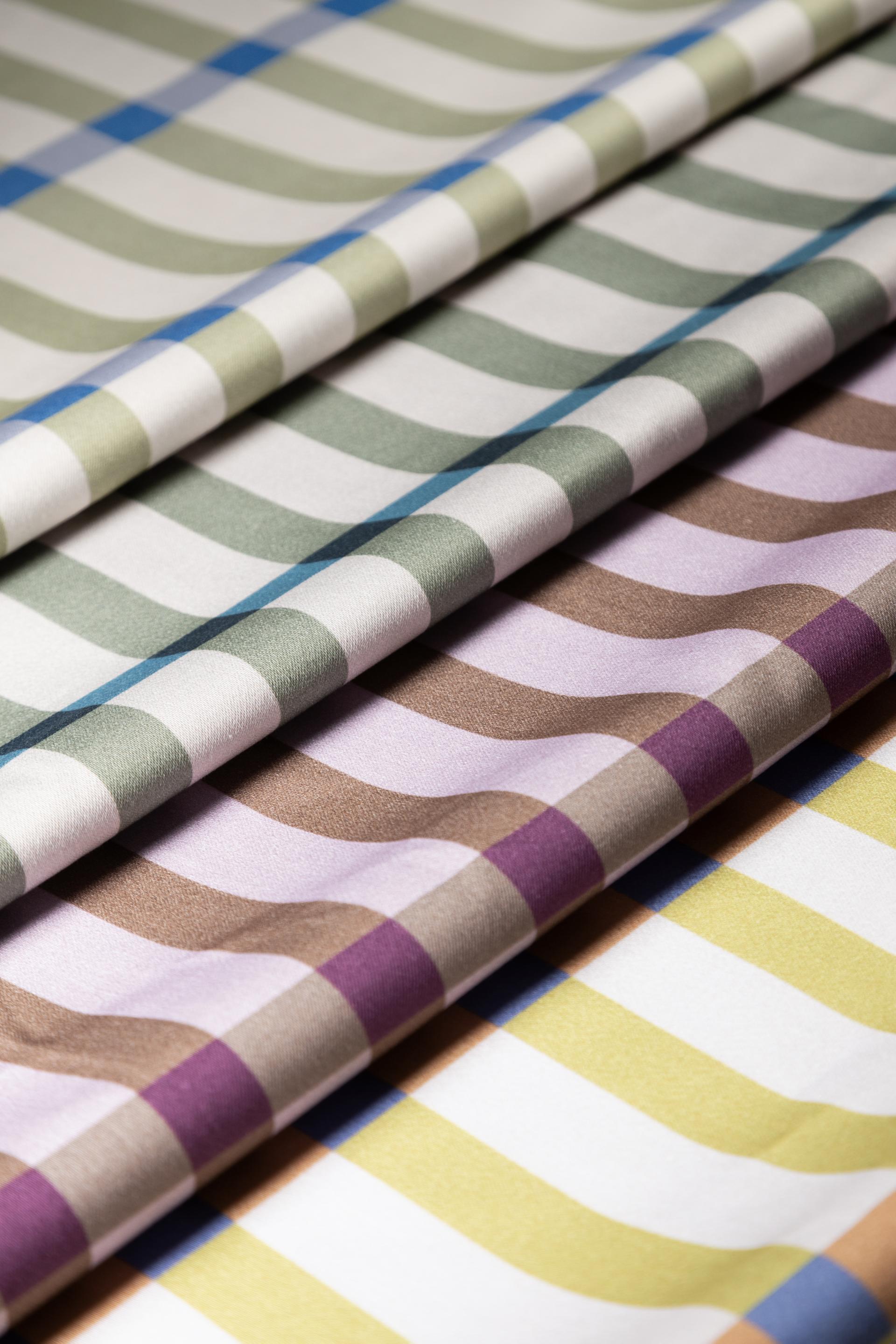 Colorful patterned fabrics displayed at the Makers in Residence showcase, highlighting Scottish design and craft at Material Source Studio.