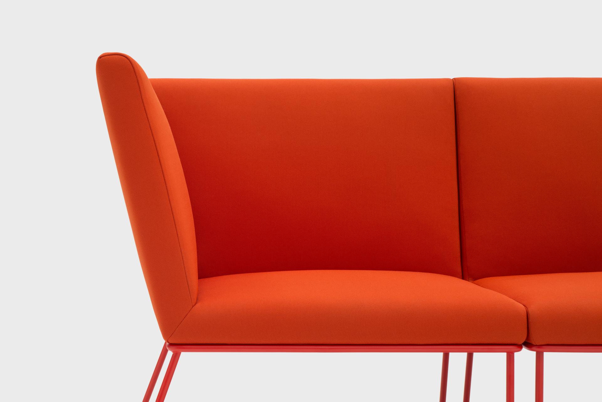 Modern orange sofa design from VIGANÒ & C., showcasing a sleek silhouette and vibrant color.