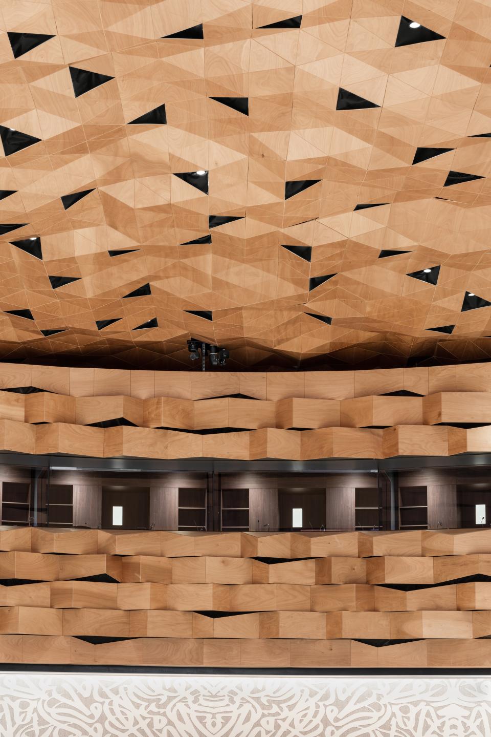 Uniform wooden cladding with geometric designs decorates the dome and walls of the United Nations Assembly Hall in Geneva.
