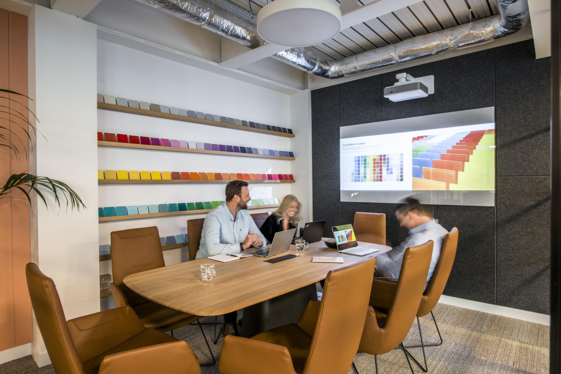 Modern meeting room showcasing Woven Image's recycled PET acoustic panels and vibrant color samples for design inspiration.