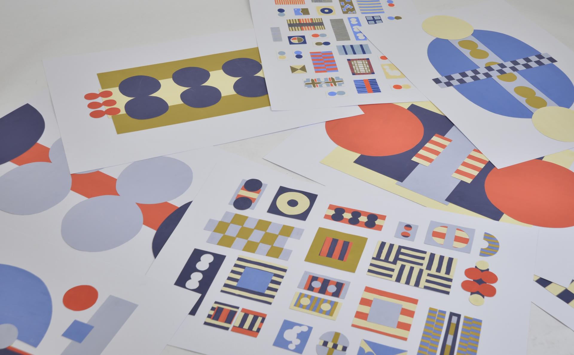 Colorful abstract art prints featuring geometric shapes, displayed in a creative layout at Manchester School of Art.