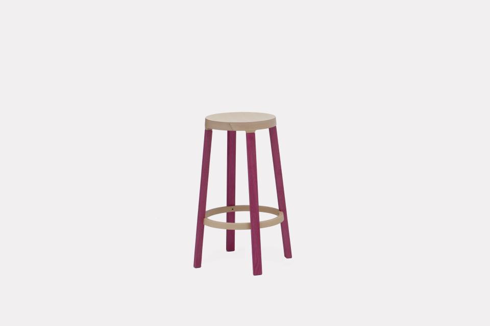 Stylish contemporary stool with a light wood seat and colorful purple legs, perfect for modern interior design.