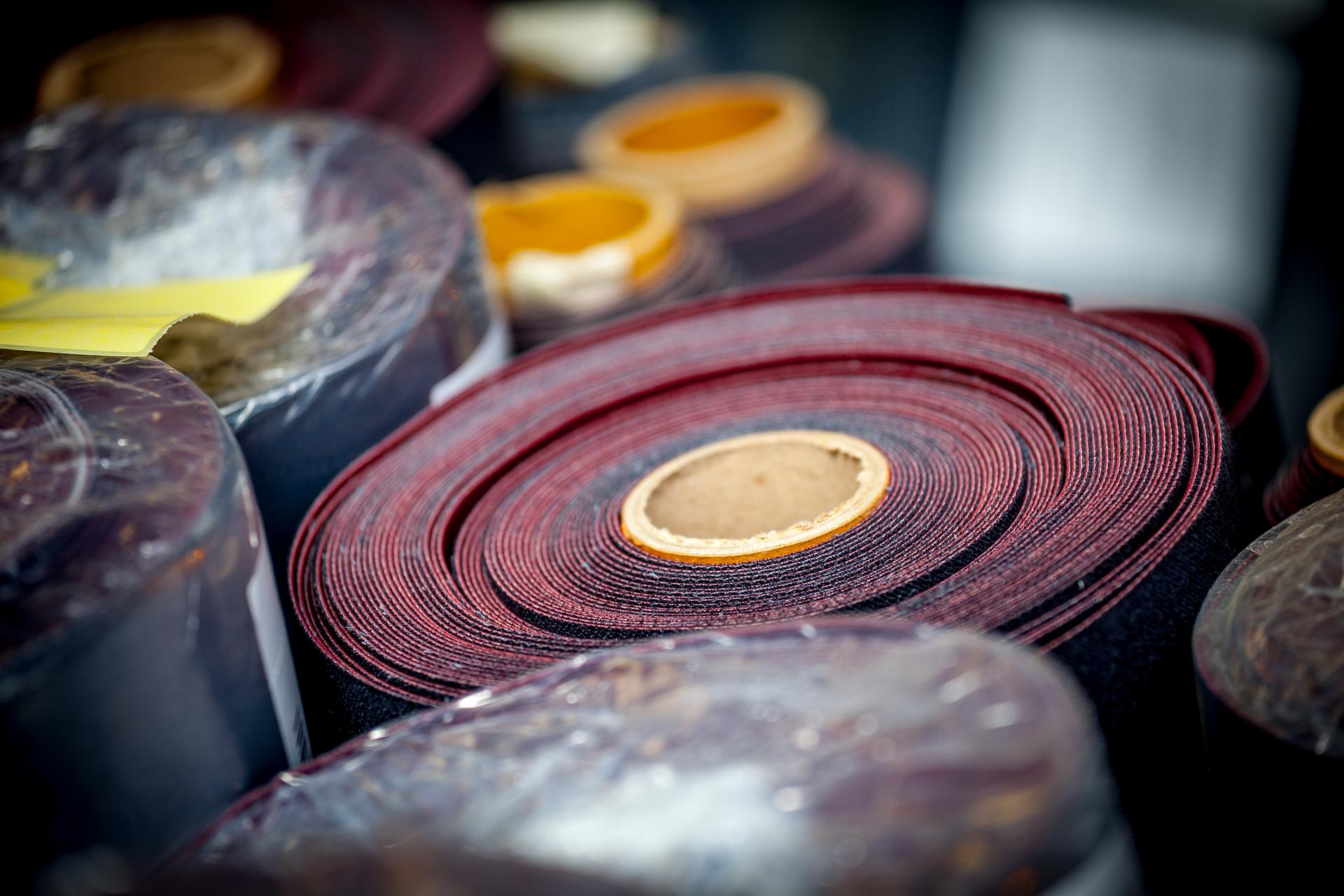 Rolls of performance upholstery fabric in various colors, showcasing Agua's innovative textile designs for modern interiors.