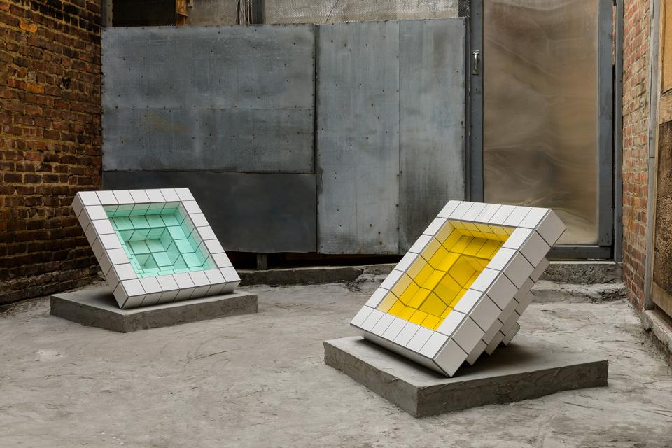 Unique sculptures made from subway tiles by artist Zac Hacmon, showcasing geometric shapes and vibrant colors in a gallery setting.