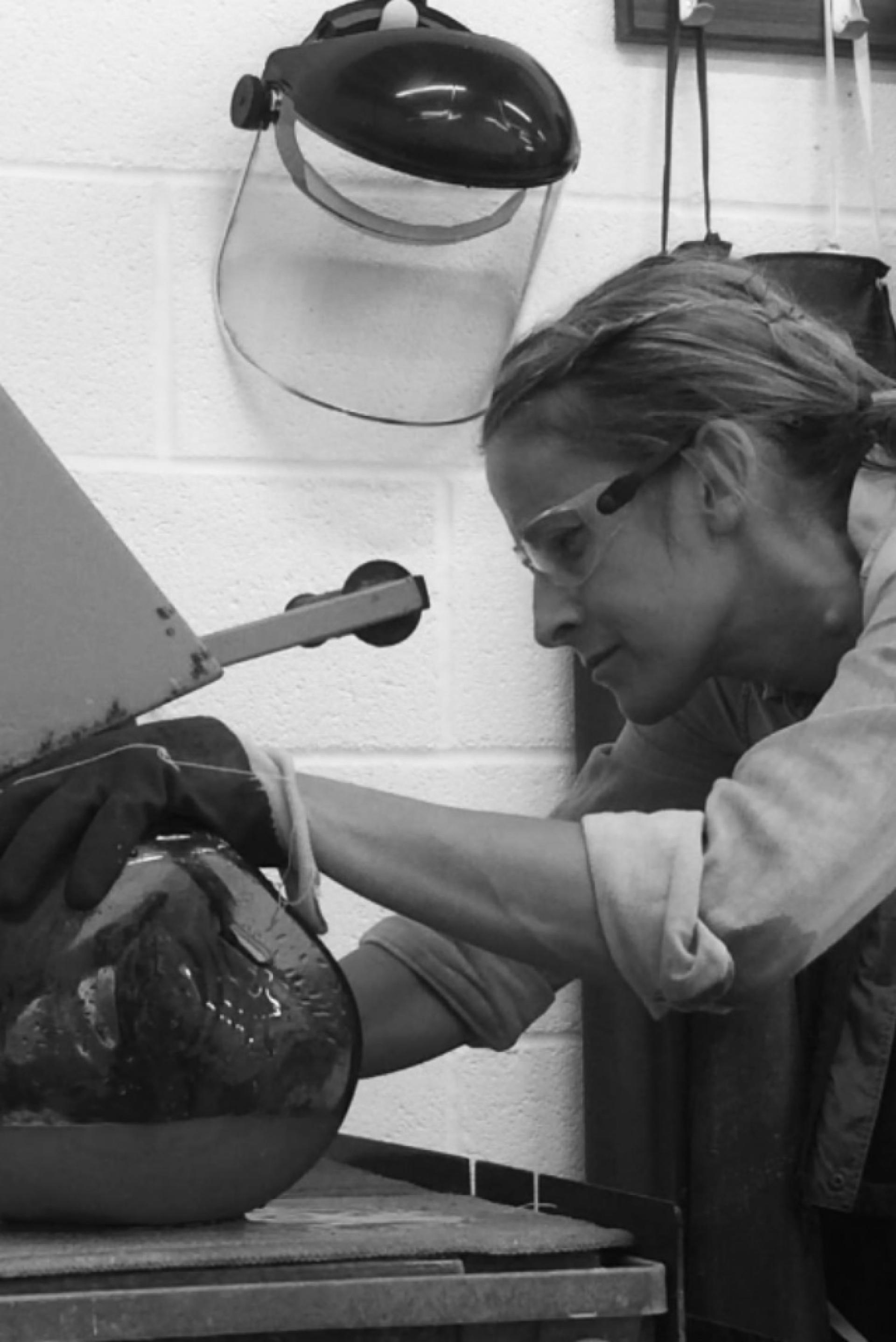 Nicola Schellander working on a unique glass sculpture, showcasing craftsmanship in the British crystal industry.