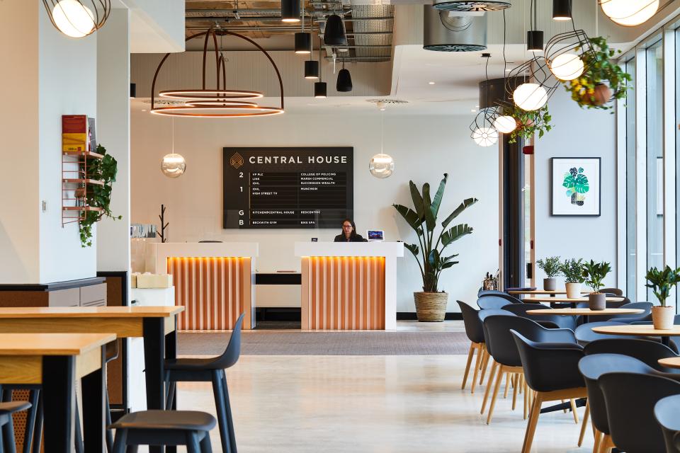 Modern reception area of Central House, featuring stylish decor, seating, plants, and a welcoming desk designed by SpaceInvader.