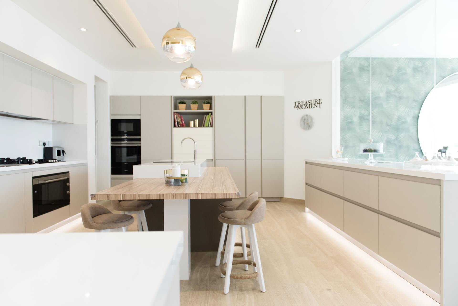 Minimalist kitchen design featuring a wooden island, modern appliances, and stylish decor on Palm Jumeirah, Dubai.