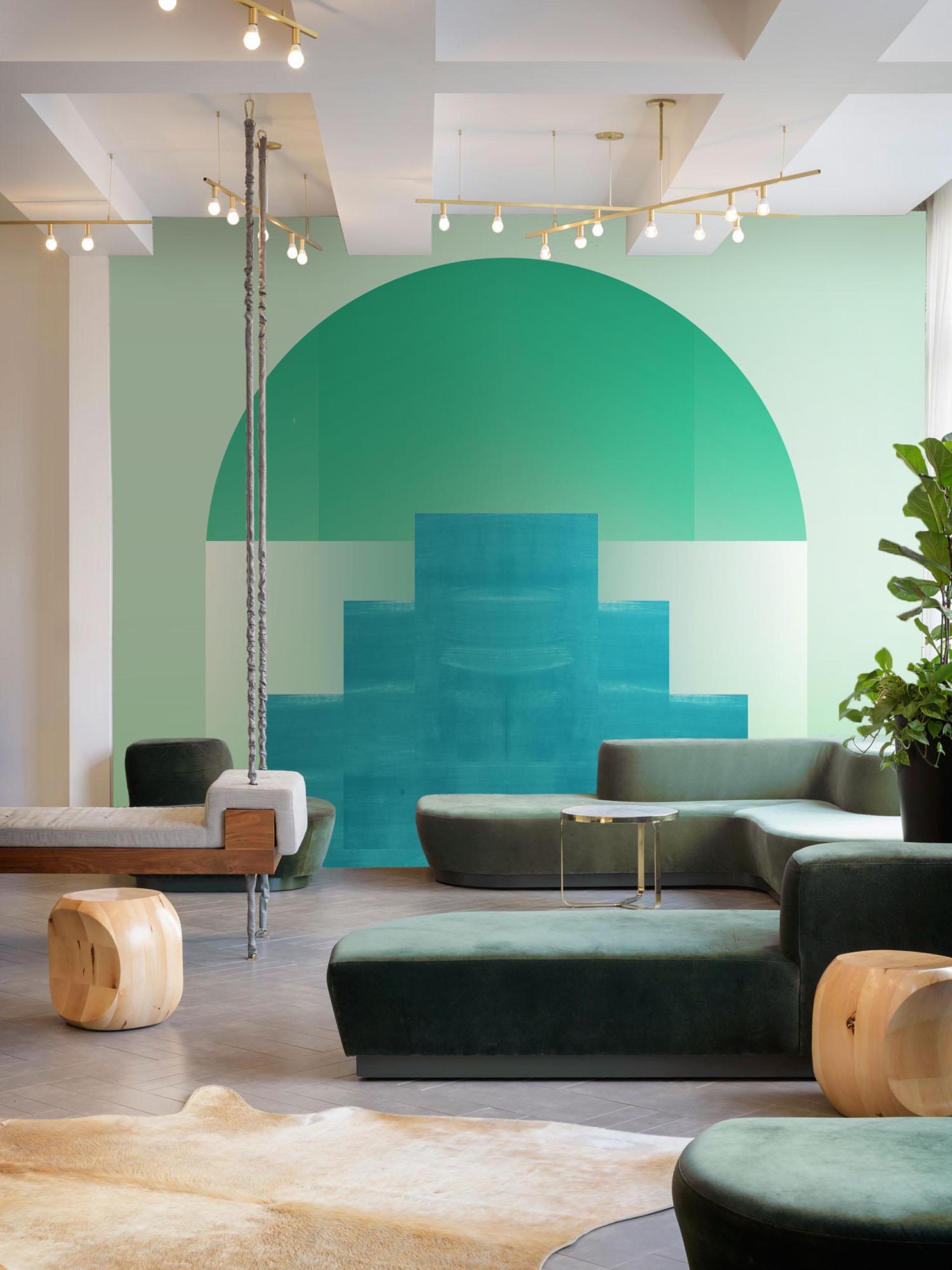 Stylish commercial interior featuring Newmor wallcoverings with vibrant green patterns, modern furniture, and ambient lighting.