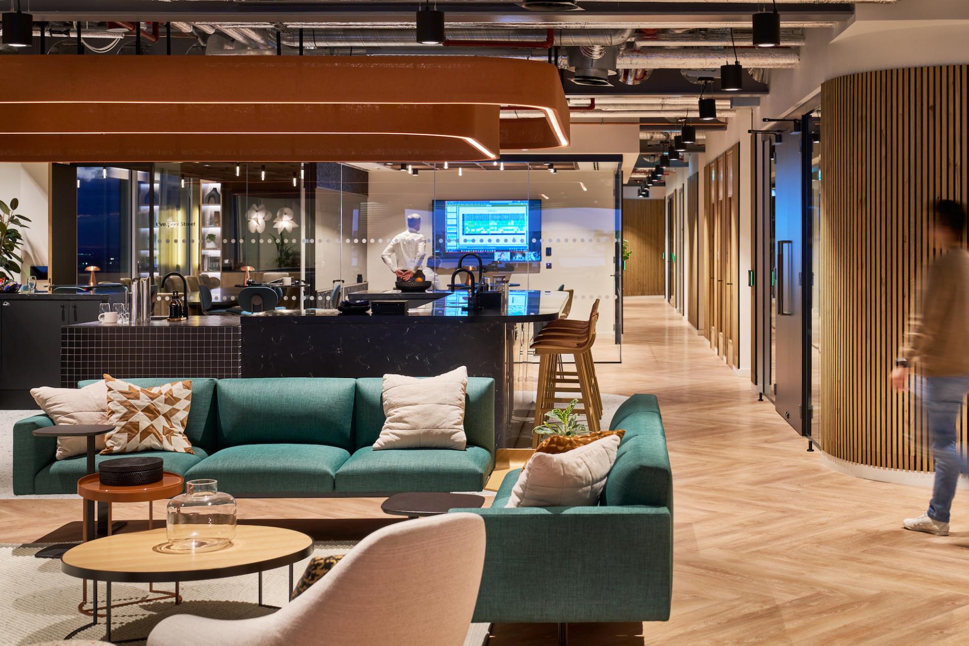 Modern workplace design featuring a stylish lounge area, bar, and collaborative space for Bentley Systems employees.