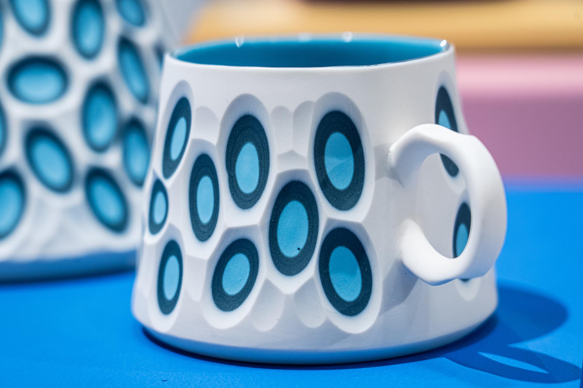 Handcrafted ceramic mug featuring a bold blue and white geometric pattern, showcased at Material Source Studio in Glasgow.