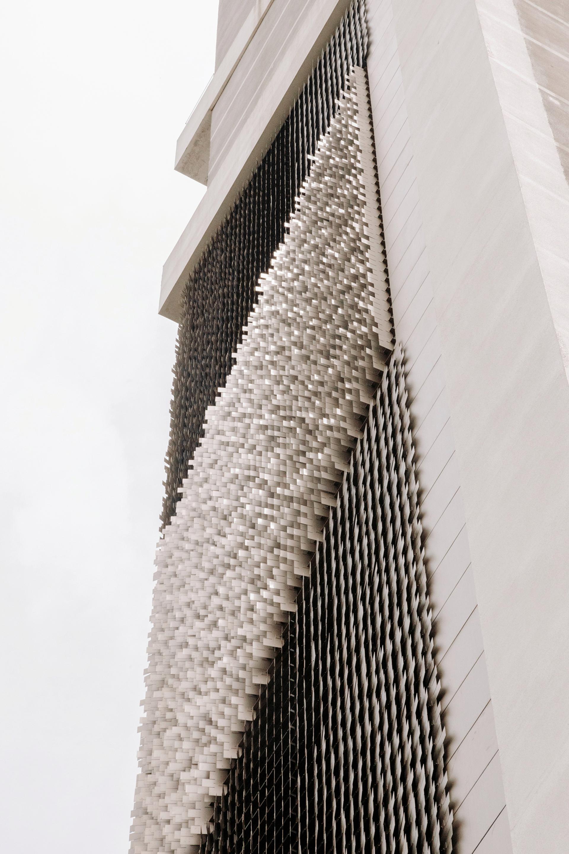 Dynamic facade showcasing innovative materiality with layered textures and patterns, reflecting Giles Miller Studio's design philosophy.