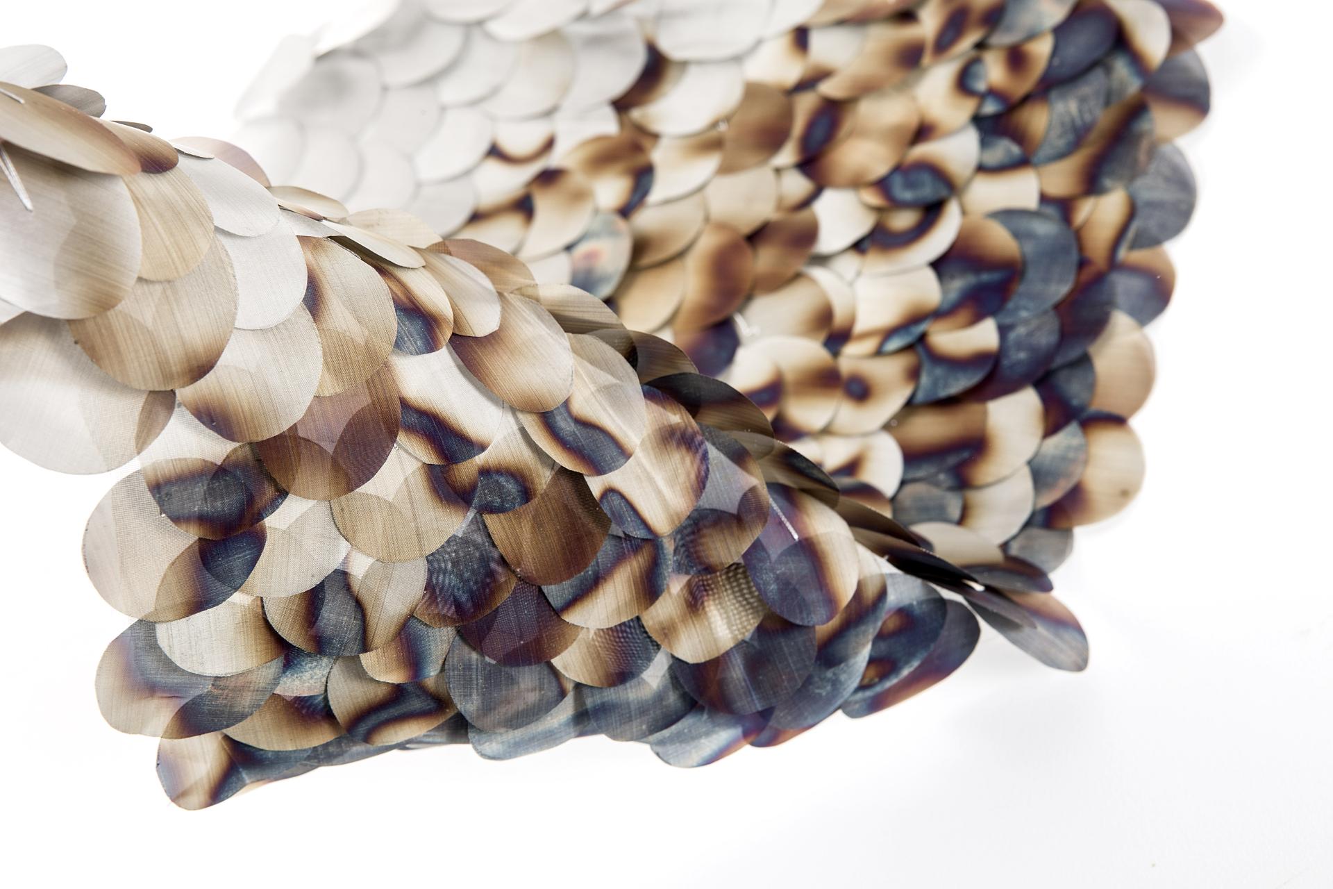 Colorful, layered material resembling fish scales, showcasing innovative design for the Surface Design Show in London.