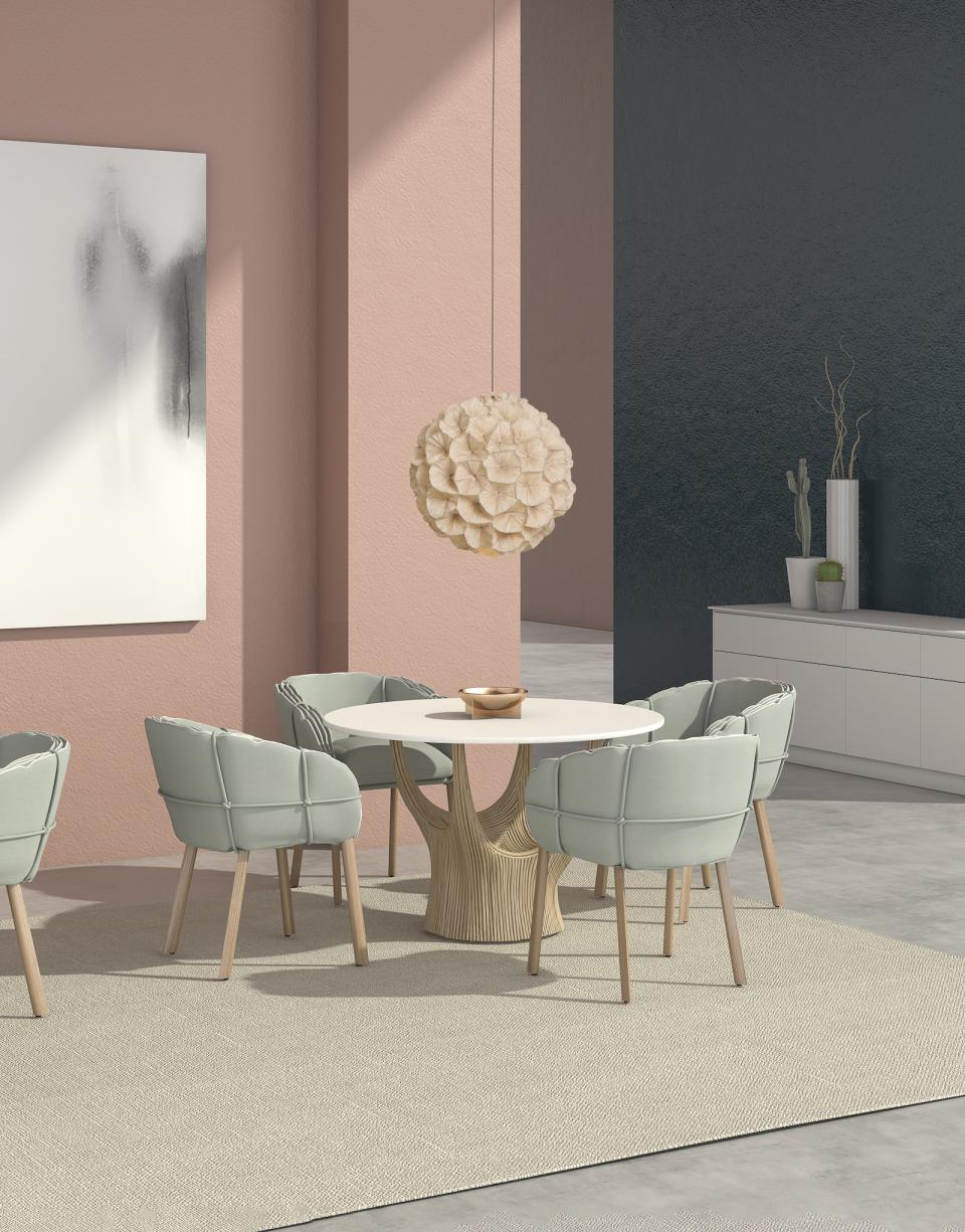 Elegant dining area featuring Kenneth Cobonpue's Parchment seating, showcasing modern design inspired by ancient manuscripts.