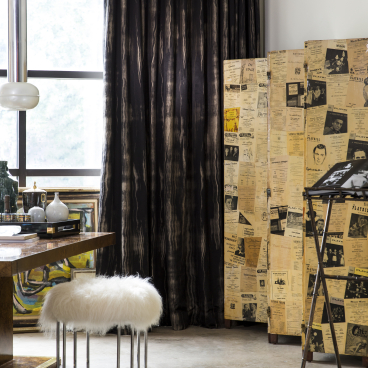 Stylish interior featuring David Rockwell's fabric curtains, a furry stool, and unique wallcoverings by Jim Thompson.