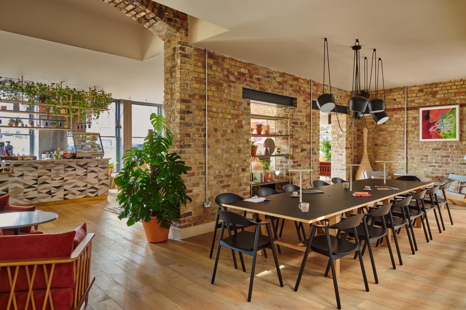 Modern interior of Zanzibar Locke aparthotel featuring a dining area with stylish decor and vibrant plants.