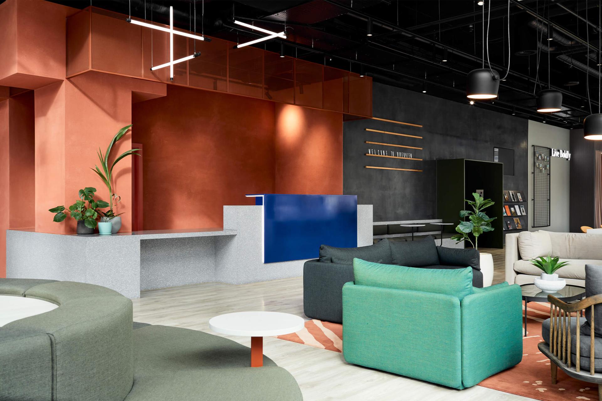 Modern interior design showcasing a vibrant reception area with colorful seating, plants, and unique textures reflecting NoChintz's creative approach.